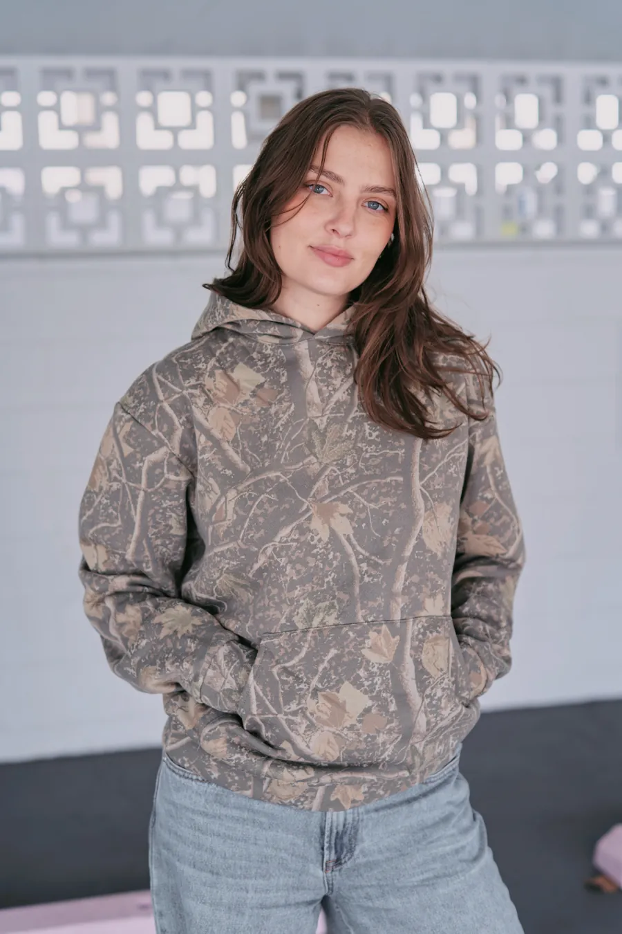 Woman wearing the Deadwood Camo Heavyweight hoodie