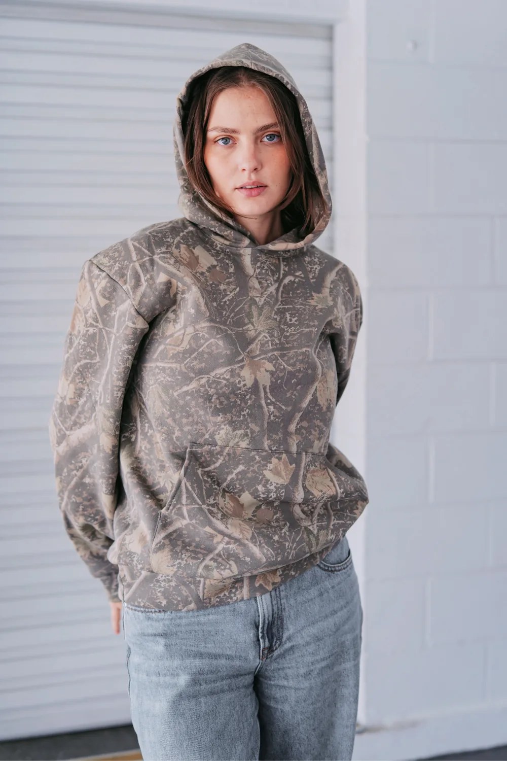 Woman wearing a Deadwood Camo heavyweight hoodie